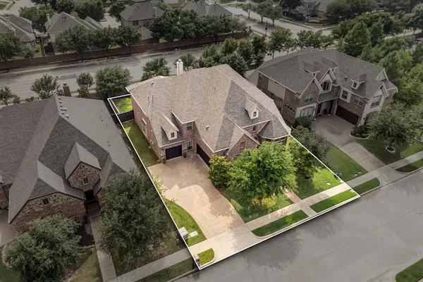 an aerial view of a house with garden space and lake view