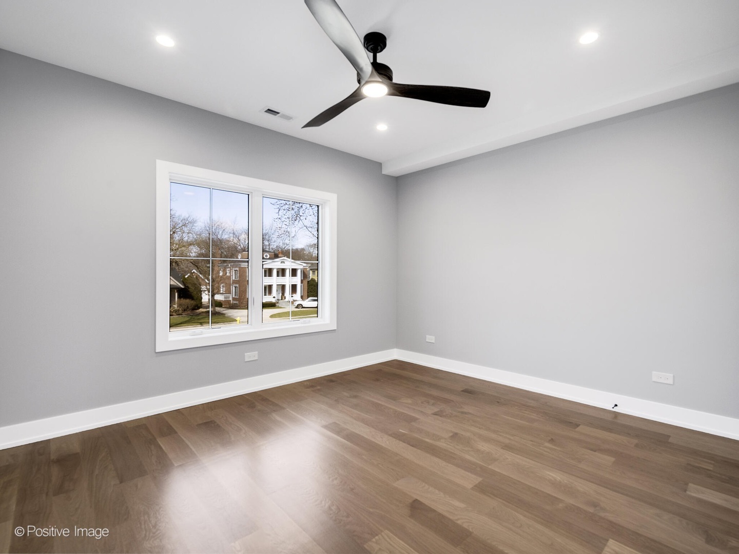 609 North County Line Road Hinsdale, IL 60521 - Photo 20 of 42 an empty room with wooden floor and windows