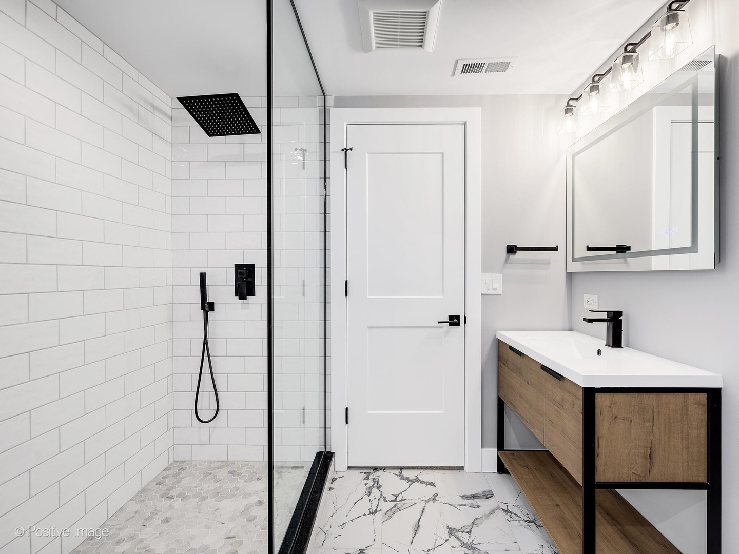 609 North County Line Road Hinsdale, IL 60521 - Photo 29 of 42 a bathroom with a double vanity sink a mirror and shower