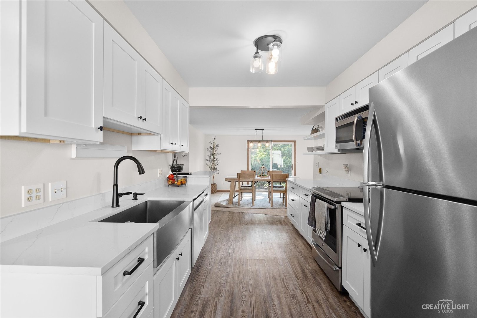 8N510 Thomas Road Hampshire, IL 60140 - Photo 11 of 33 a kitchen with white cabinets and stainless steel appliances