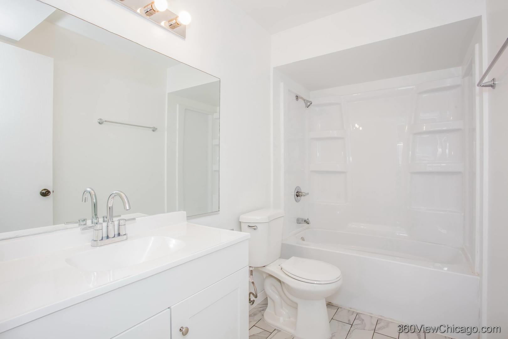 7459 North Waukegan Road, Unit 3 Niles, IL 60714 - Photo 11 of 17 a bathroom with a sink a toilet and shower