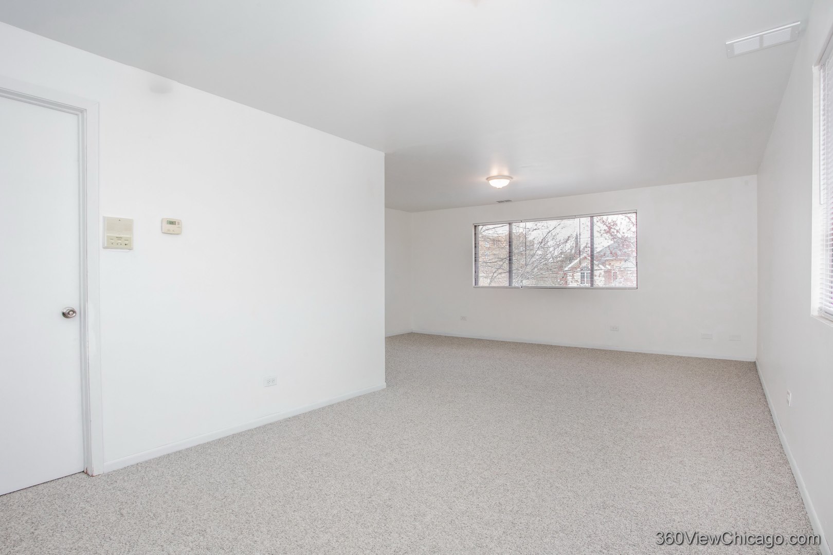 7459 North Waukegan Road, Unit 3 Niles, IL 60714 - Photo 2 of 17 an empty room with windows