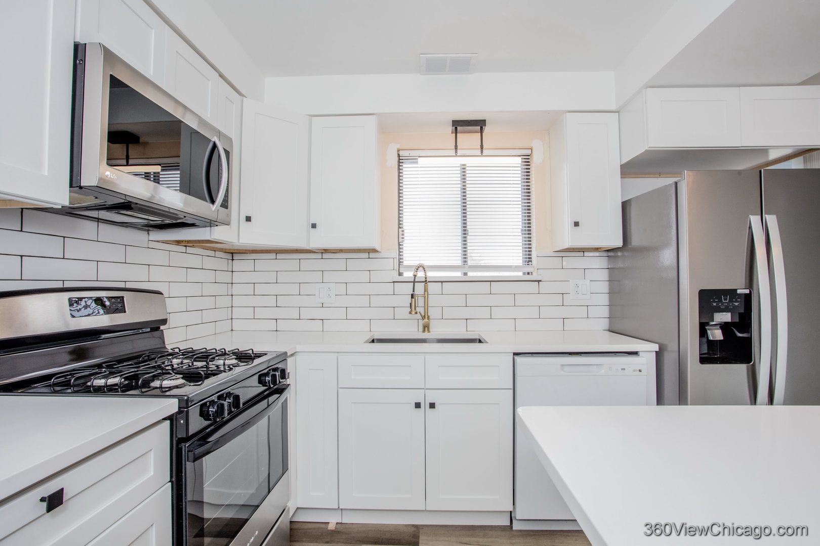 7459 North Waukegan Road, Unit 3 Niles, IL 60714 - Photo 5 of 17 a kitchen with stainless steel appliances a sink a stove a microwave a refrigerator a sink and cabinets