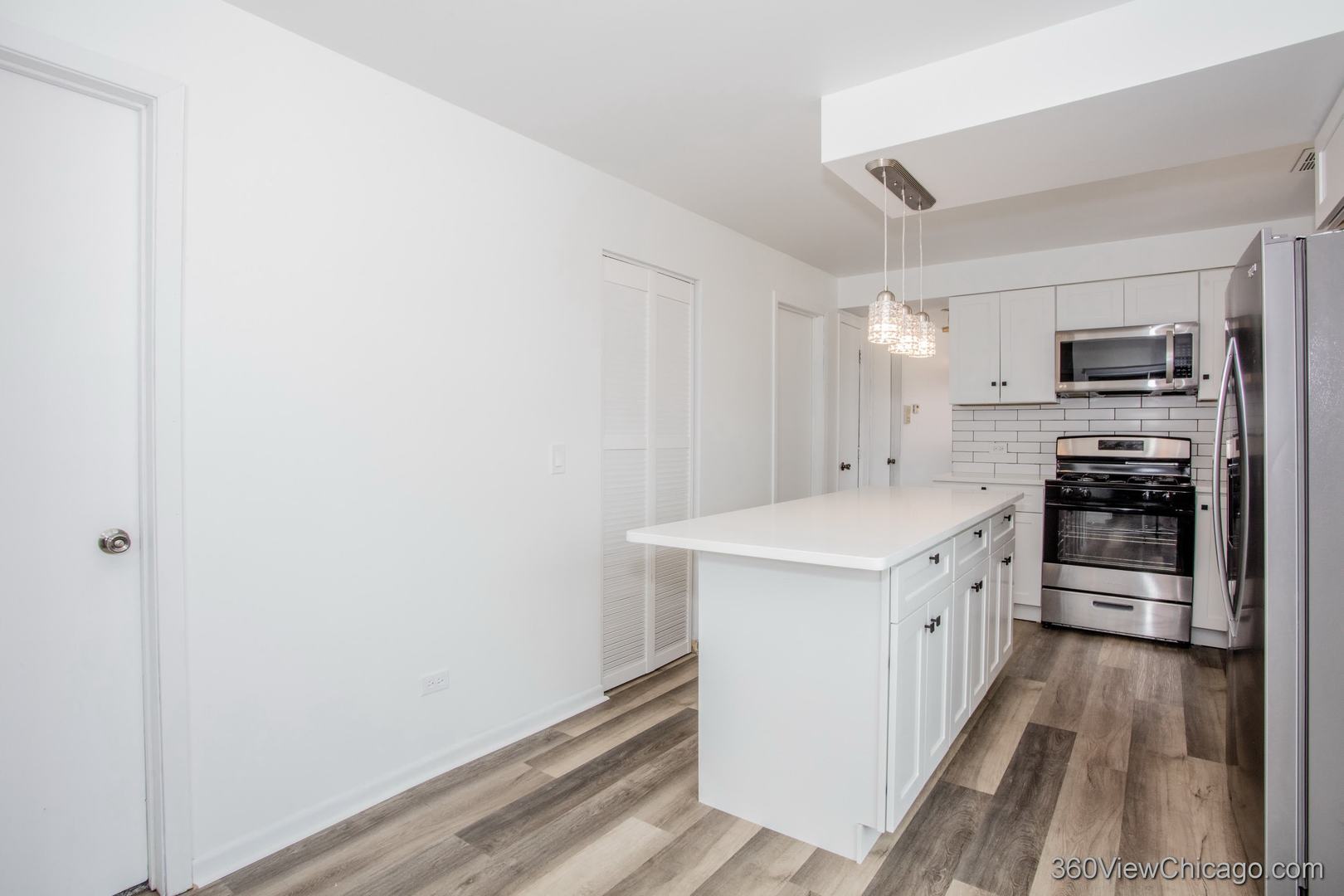 7459 North Waukegan Road, Unit 3 Niles, IL 60714 - Photo 6 of 17 a kitchen with a sink a stove top oven and refrigerator