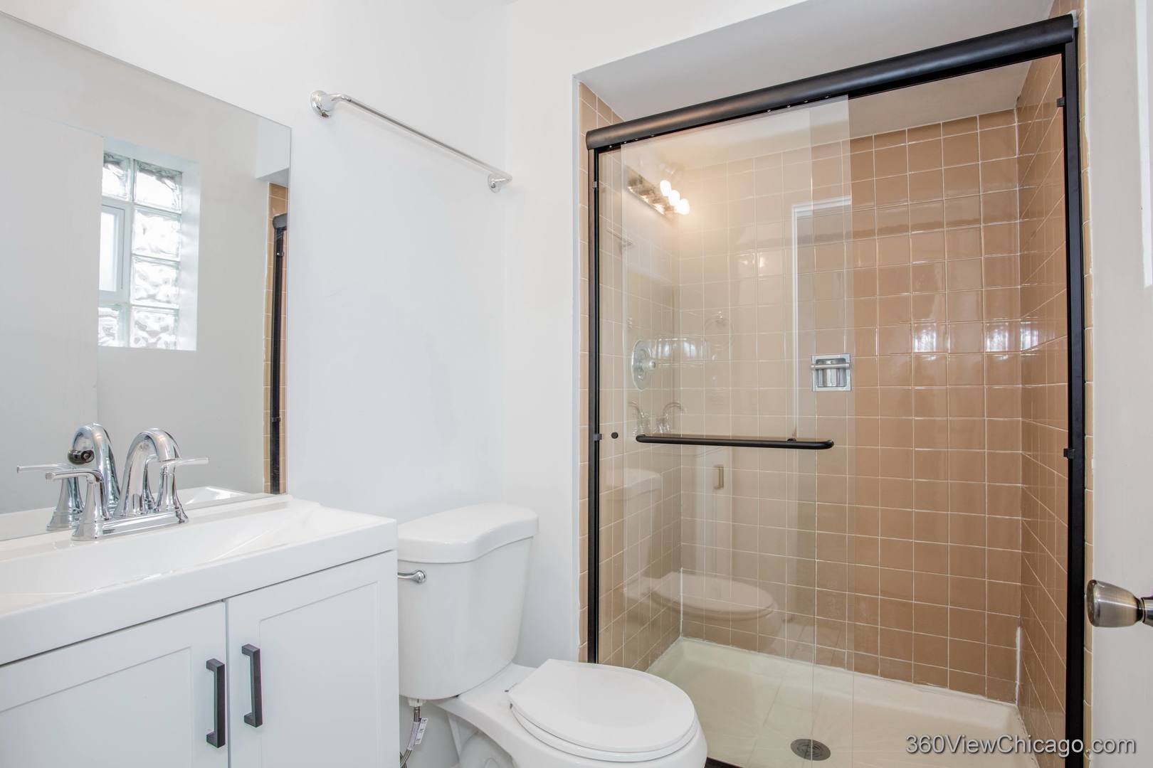 7459 North Waukegan Road, Unit 3 Niles, IL 60714 - Photo 8 of 17 a bathroom with a shower a sink a toilet and mirror