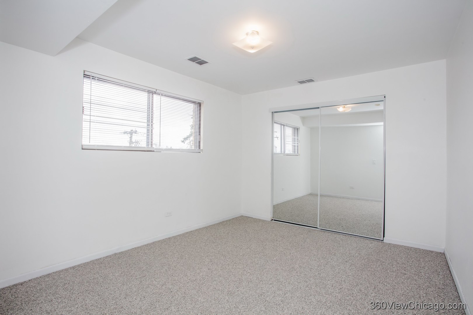 7459 North Waukegan Road, Unit 3 Niles, IL 60714 - Photo 10 of 17 an empty room with windows and closet