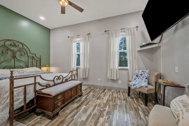 a bathroom with a granite countertop sink toilet a mirror and shower
