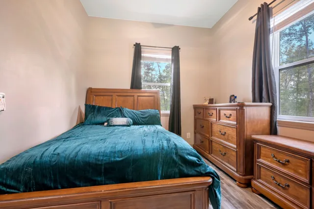 a room with pool table and windows