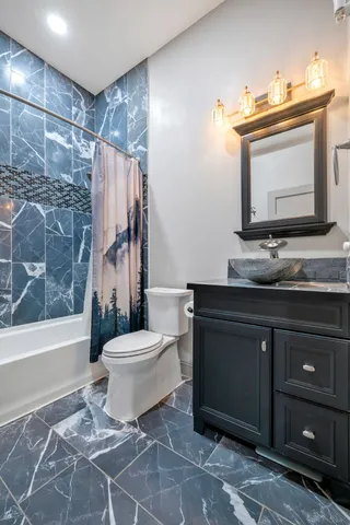 a bedroom with a large bed window and closet