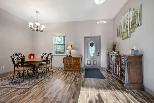 a kitchen with stainless steel appliances granite countertop a refrigerator a stove and a wooden floors