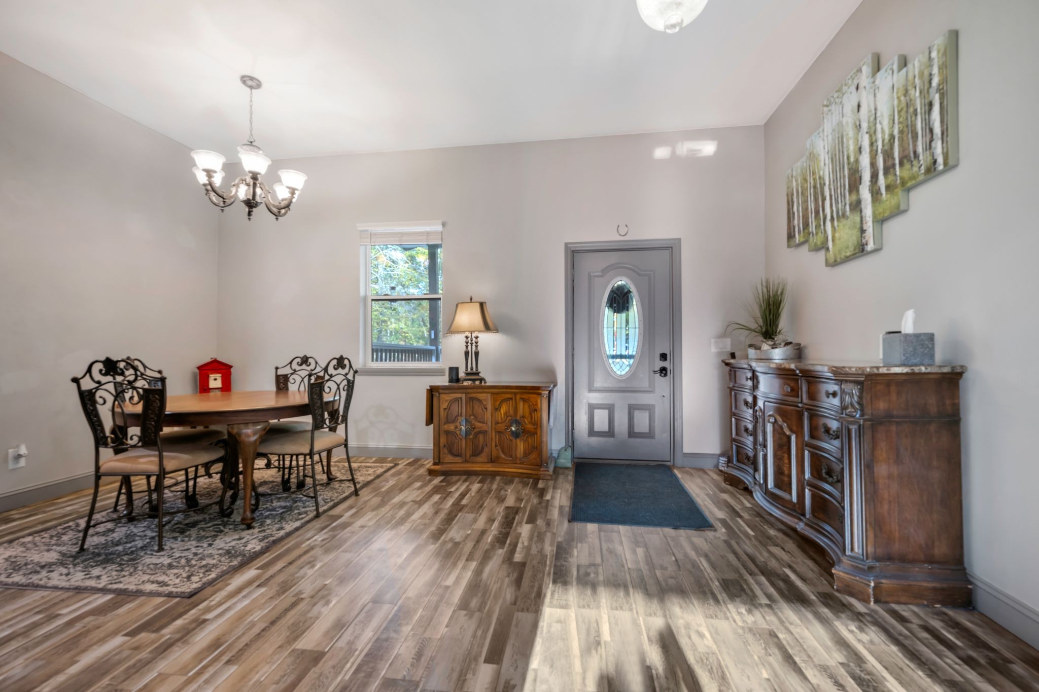 399 Coaling Road Charlotte, TN 37036 - Photo 7 of 73 a view of a dining room with furniture a chandelier and wooden floor