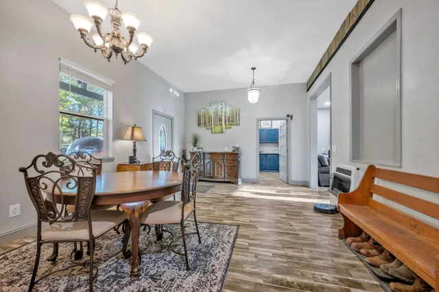 a bedroom with a bed couch and a flat tv screen