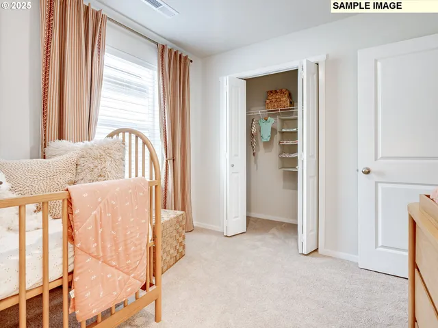 a view of a bedroom with wooden floor and windows