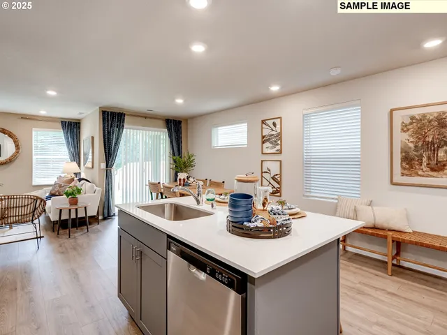 a kitchen with a sink cabinets and wooden floor