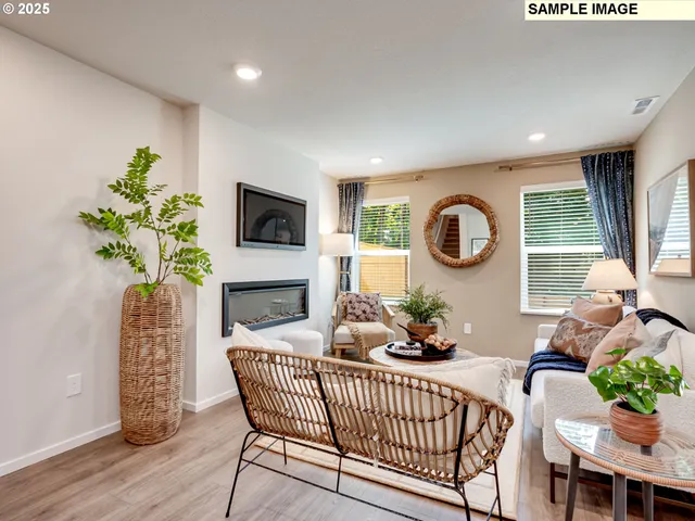a living room with furniture potted plant and a window