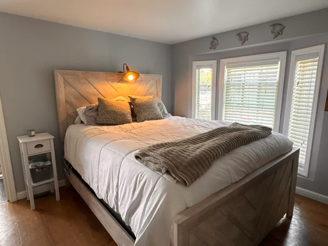 a bedroom with a bed and a window