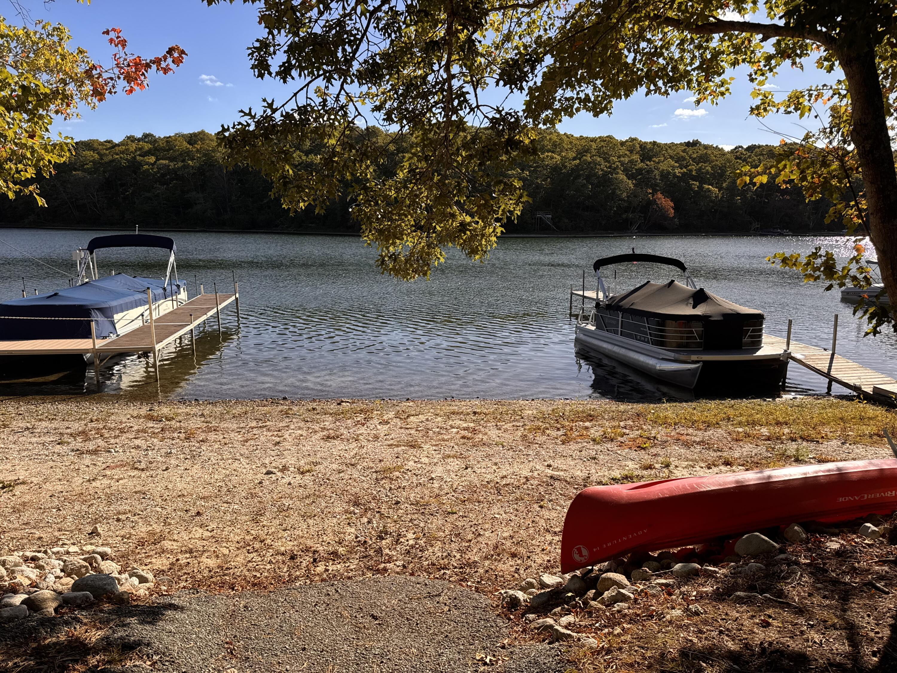 185 Cotuit Road, Unit BE4 Sandwich, MA 02563 - Photo 29 of 29 a view of a backyard with couches under an umbrella