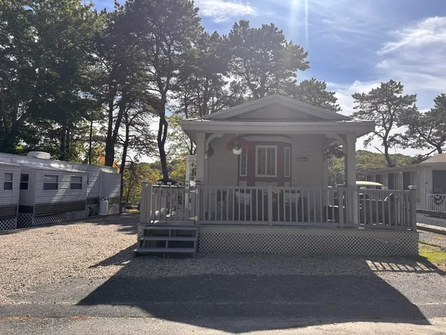 a view of a house with a wooden fence