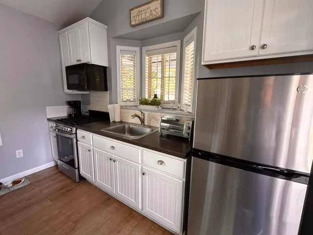 a kitchen with a refrigerator and a sink