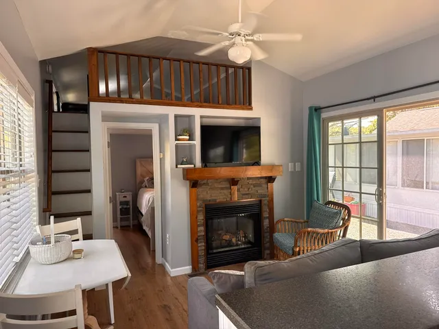 a living room with furniture a fireplace and a flat screen tv