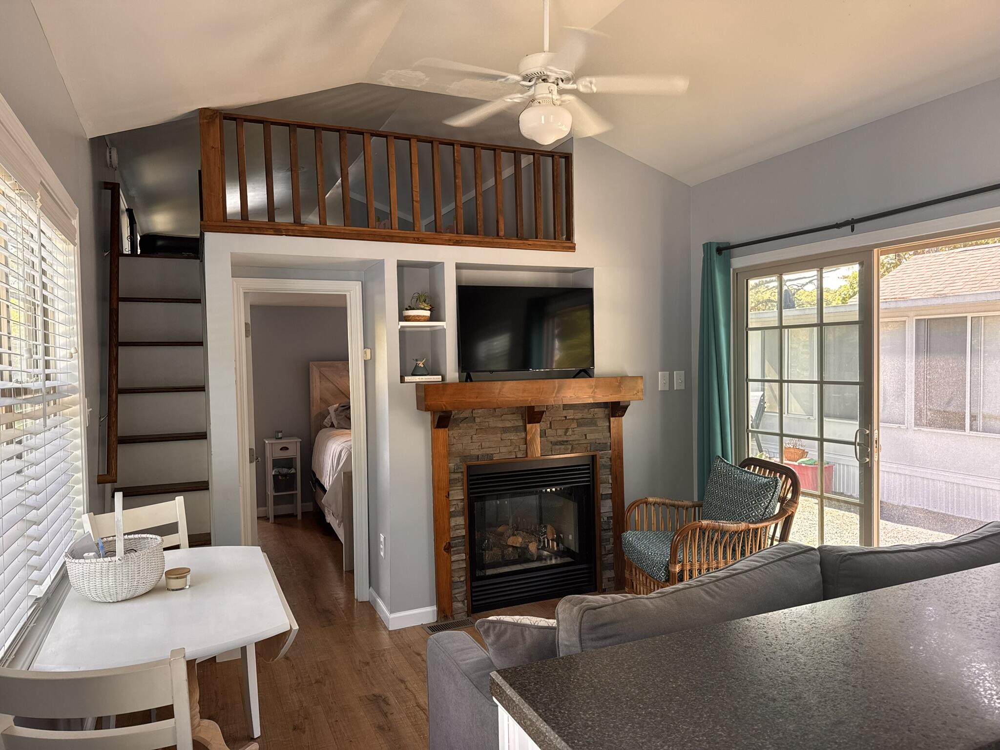 185 Cotuit Road, Unit BE4 Sandwich, MA 02563 - Photo 9 of 29 a living room with furniture a fireplace and a flat screen tv