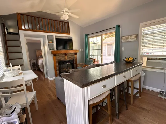 a kitchen with stainless steel appliances granite countertop a sink a stove and a refrigerator