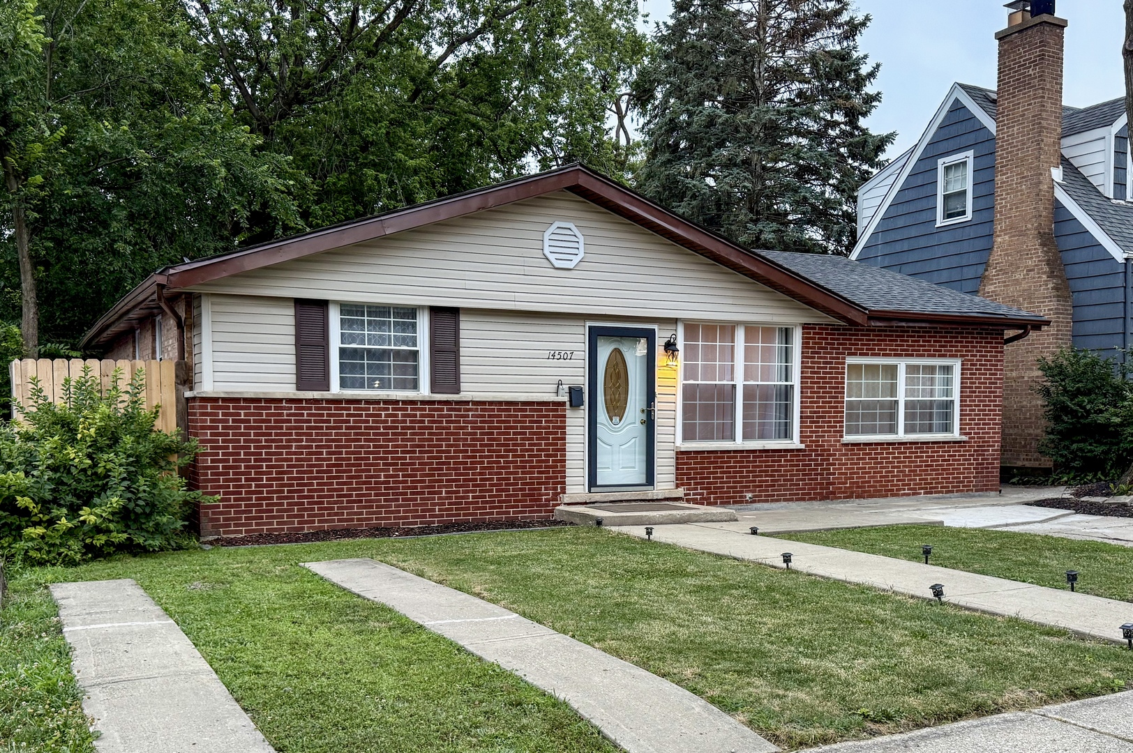 14507 Ridgeway Avenue Midlothian, IL 60445 - Photo 1 of 12 a front view of a house with a yard and garage