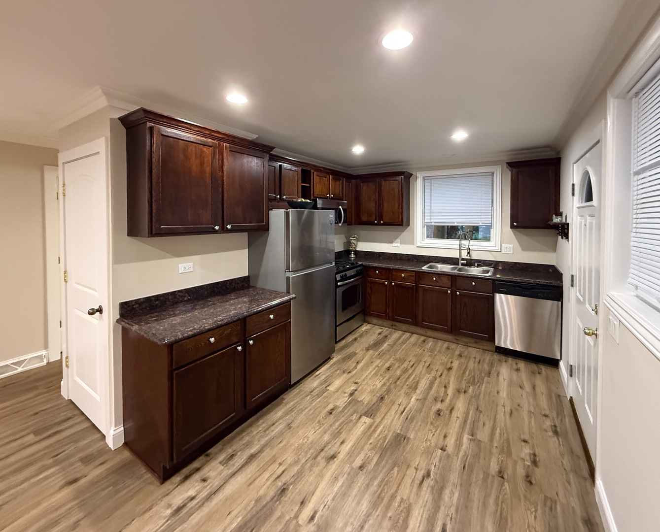 14507 Ridgeway Avenue Midlothian, IL 60445 - Photo 3 of 12 a kitchen with wooden cabinets stainless steel appliances a sink and a window