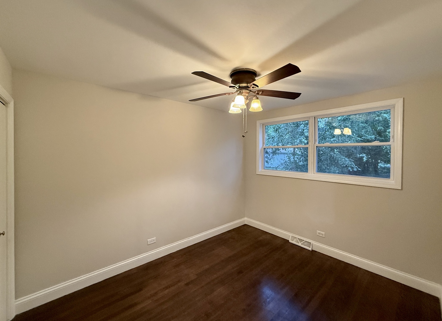 14507 Ridgeway Avenue Midlothian, IL 60445 - Photo 6 of 12 an empty room with wooden floor and windows