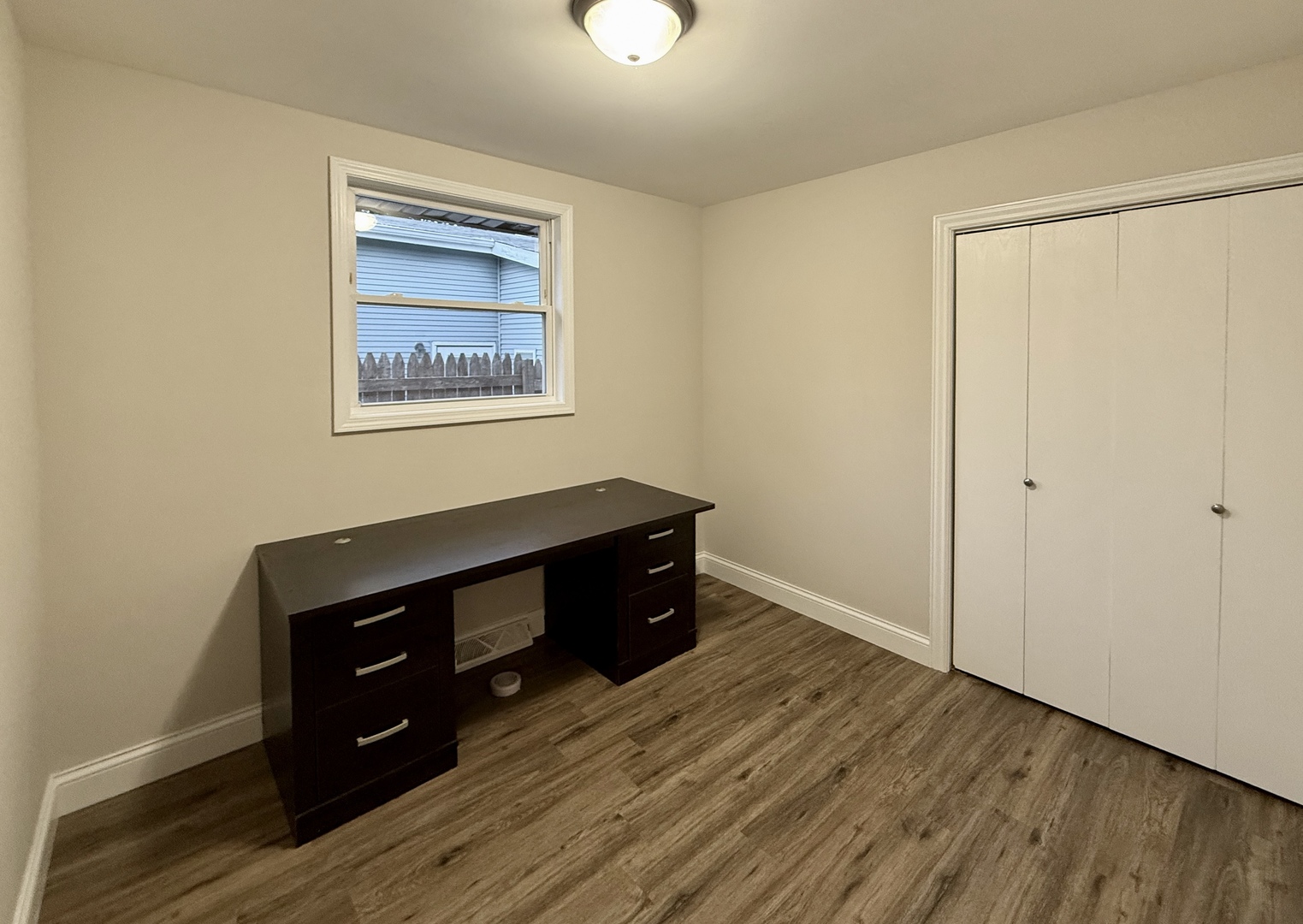 14507 Ridgeway Avenue Midlothian, IL 60445 - Photo 8 of 12 an empty room with wooden floor closet and windows