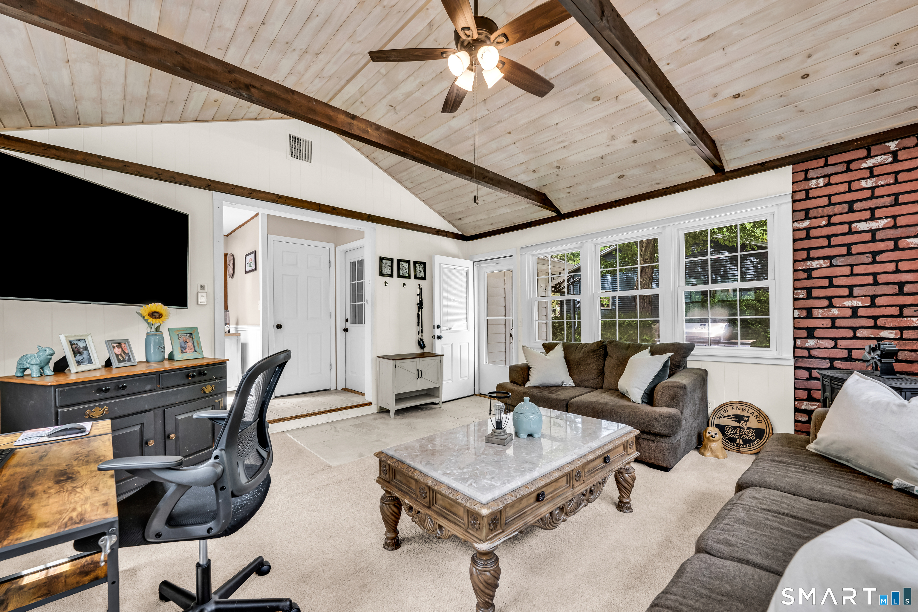 2 Hemlock Road Prospect, CT 06712 - Photo 11 of 27 a living room with furniture a flat screen tv and a large window