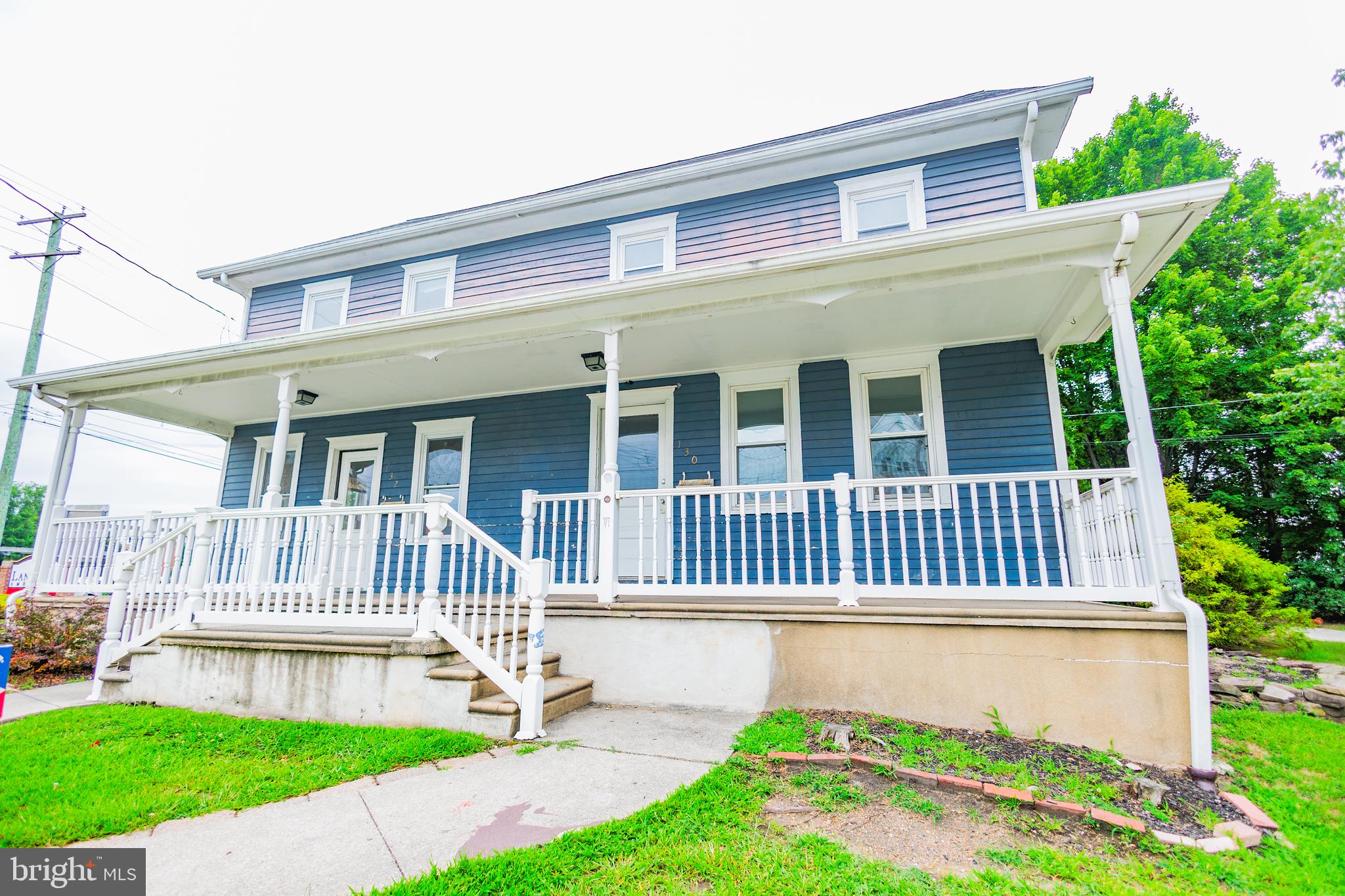 a front view of a house with a garden and deck