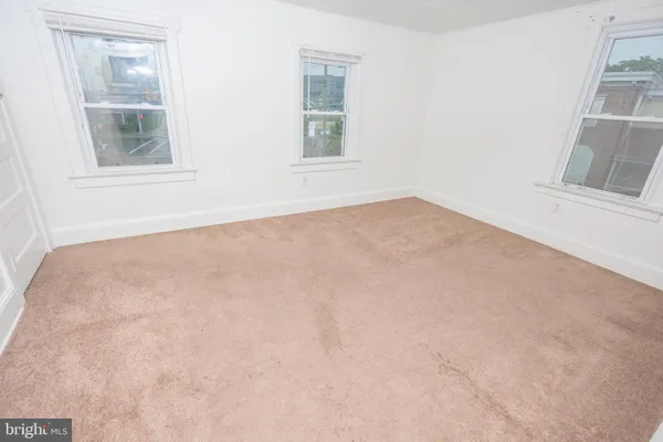 an empty room with windows and entrance