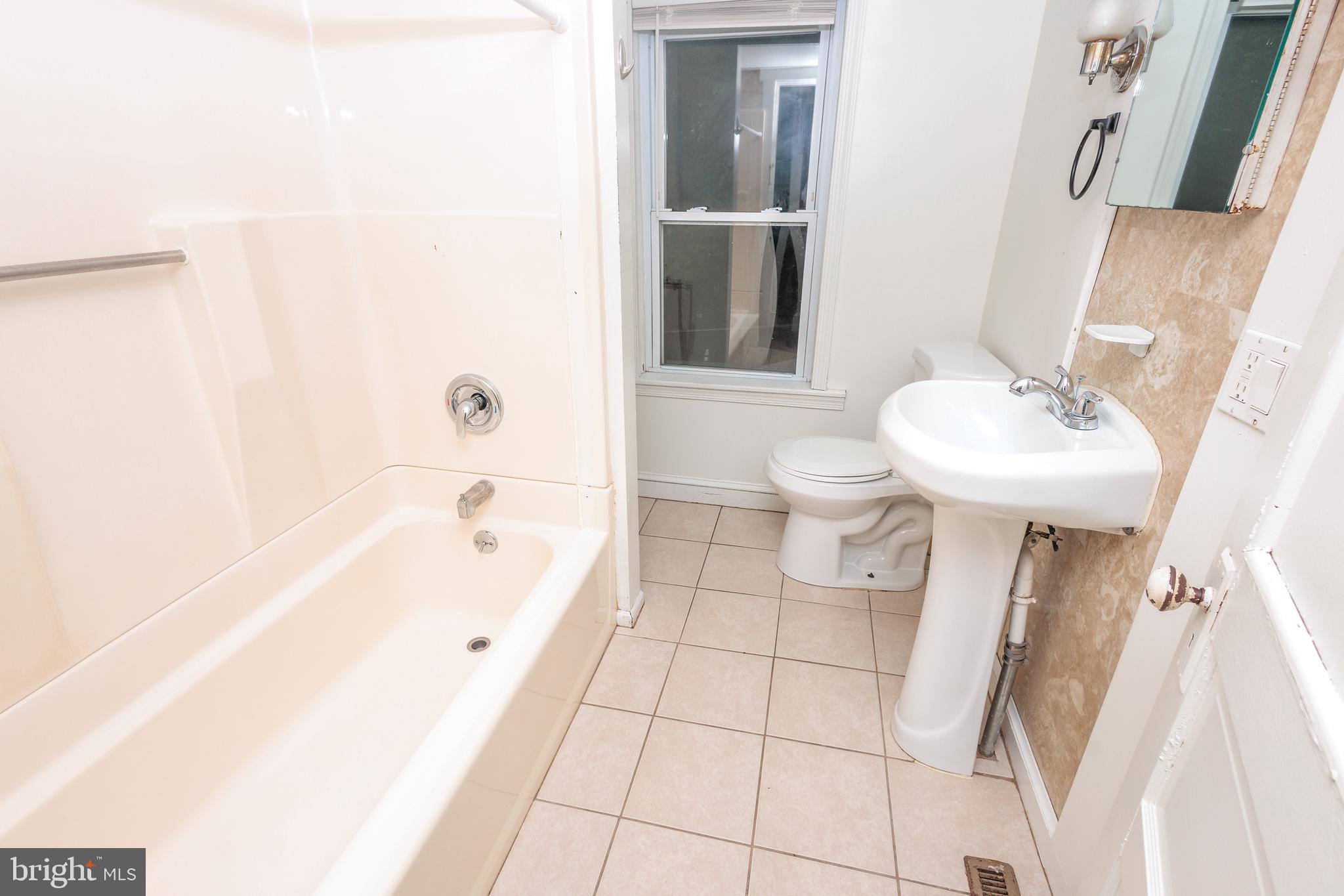 132 State Street Glassboro, NJ 08028 - Photo 19 of 19 a bathroom with a sink a toilet and shower
