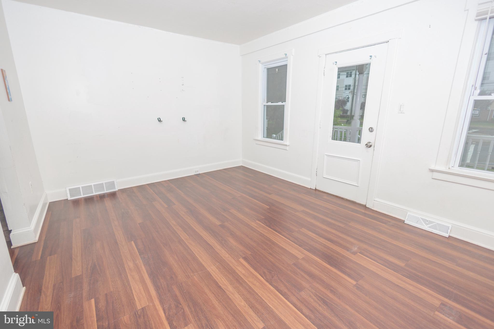 132 State Street Glassboro, NJ 08028 - Photo 8 of 19 an empty room with wooden floor and windows