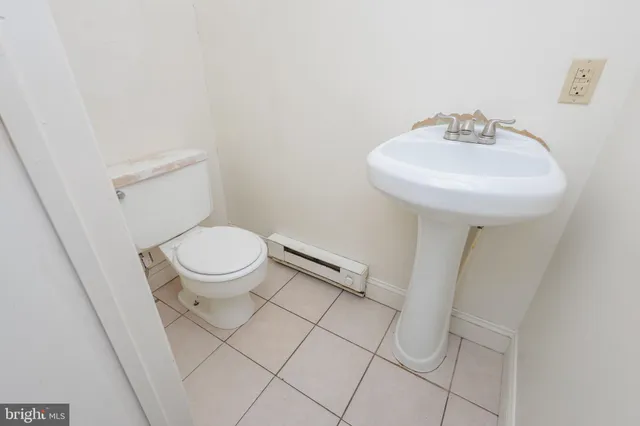 a bathroom with a sink toilet and a mirror