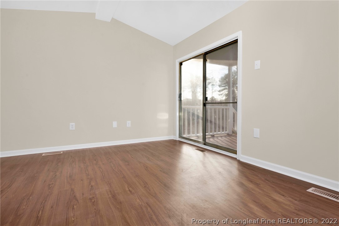 6129 Fisher Road Fayetteville, NC 28306 - Photo 14 of 31 an empty room with wooden floor and windows