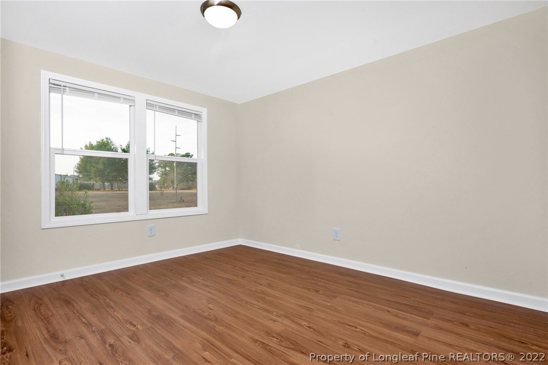 6129 Fisher Road Fayetteville, NC 28306 - Photo 17 of 31 wooden floor in an empty room with a window