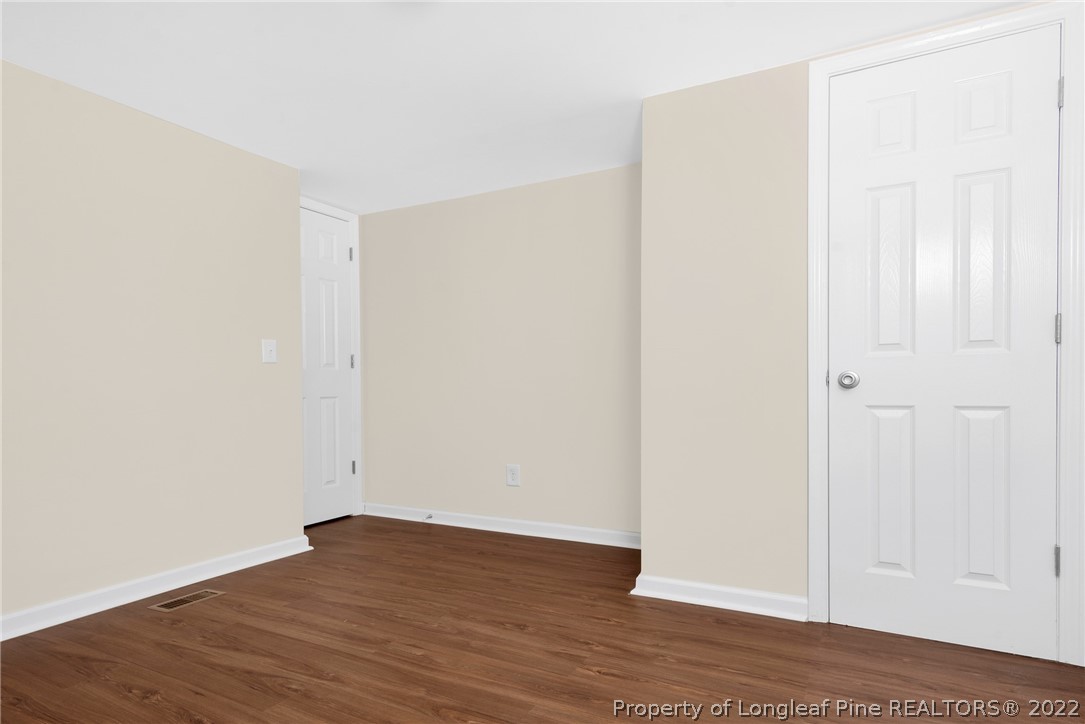 6129 Fisher Road Fayetteville, NC 28306 - Photo 18 of 31 a view of an empty room with wooden floor