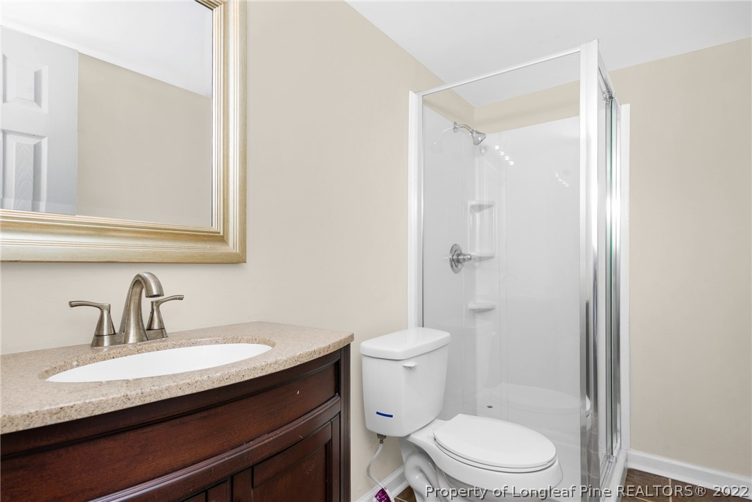 6129 Fisher Road Fayetteville, NC 28306 - Photo 19 of 31 a bathroom with a sink a toilet and shower