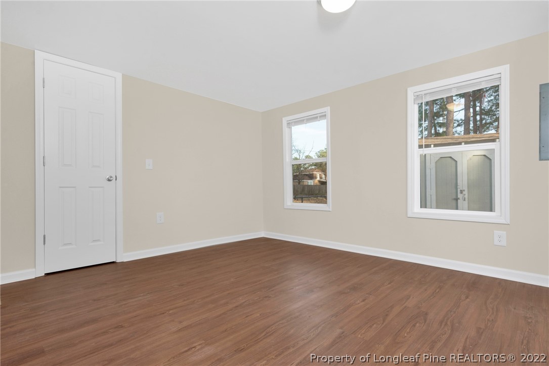 6129 Fisher Road Fayetteville, NC 28306 - Photo 20 of 31 a view of an empty room with wooden floor and a window