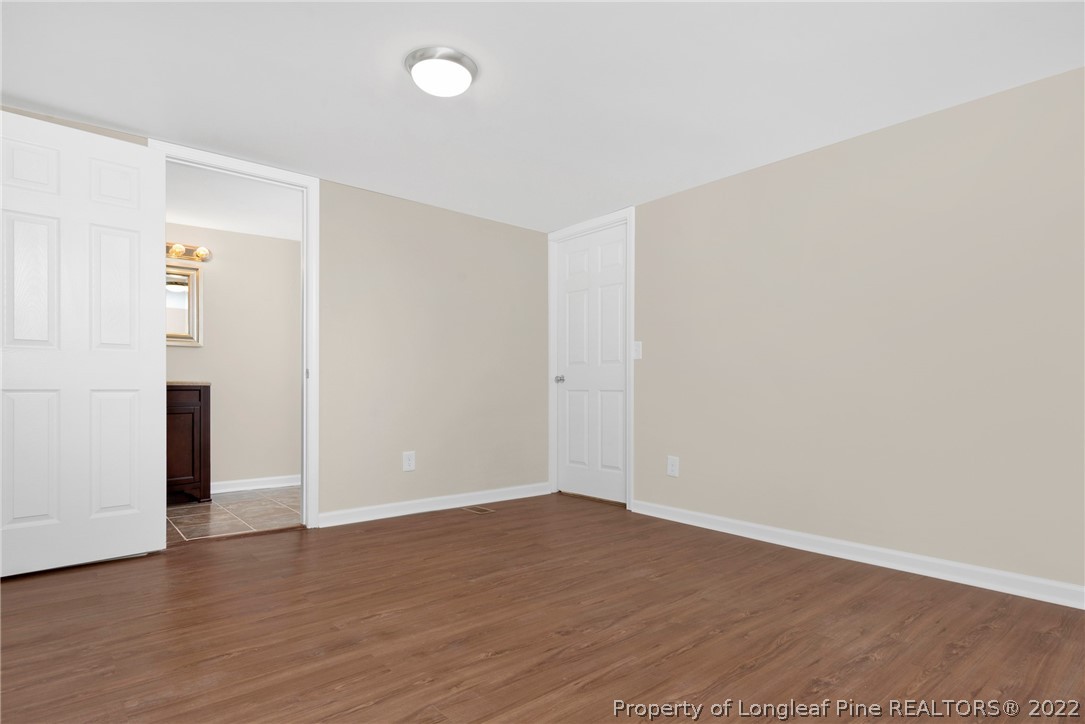 6129 Fisher Road Fayetteville, NC 28306 - Photo 21 of 31 a view of an empty room with wooden floor