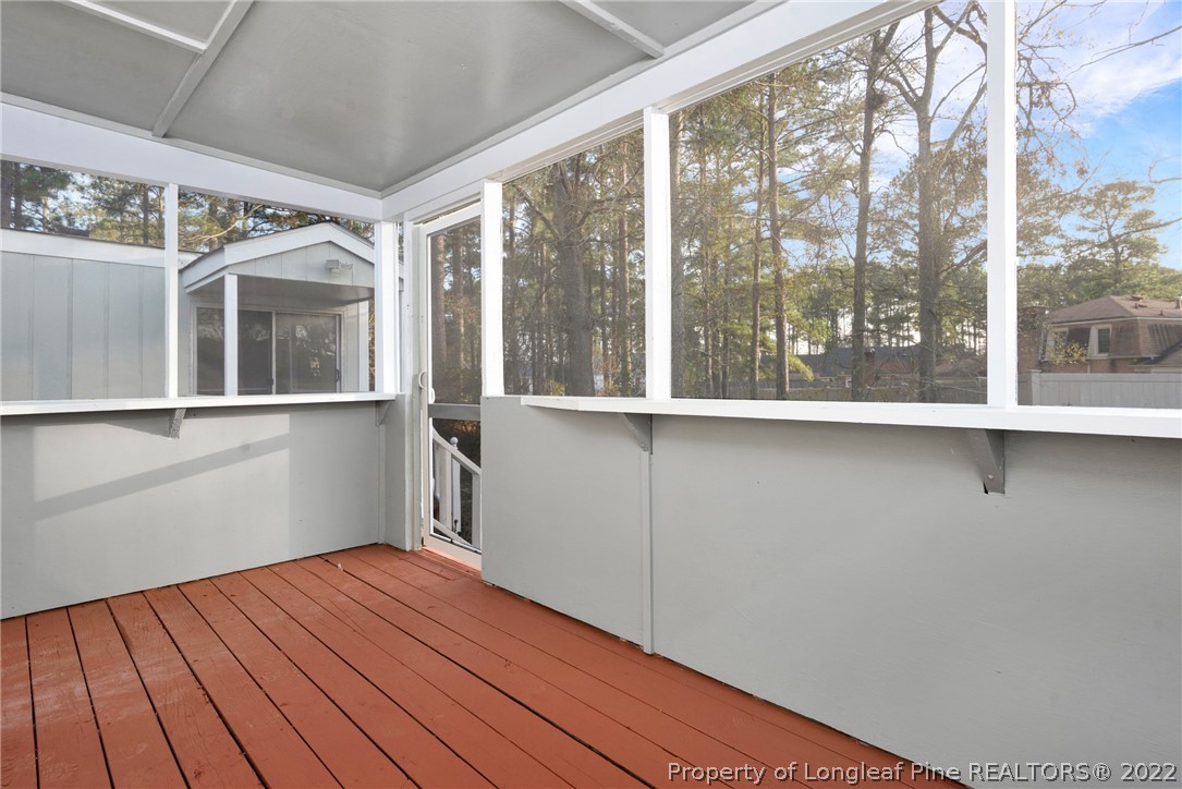 6129 Fisher Road Fayetteville, NC 28306 - Photo 24 of 31 a view of an empty room with a window and wooden floor