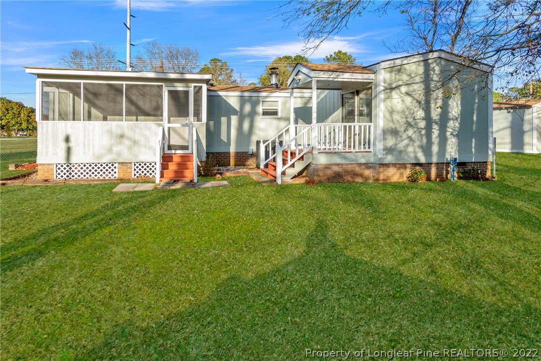 6129 Fisher Road Fayetteville, NC 28306 - Photo 25 of 31 a view of a house with a backyard