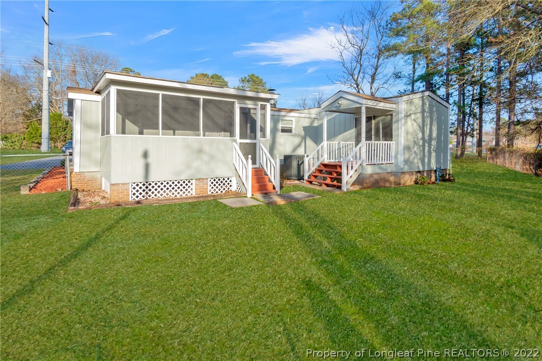 6129 Fisher Road Fayetteville, NC 28306 - Photo 26 of 31 a view of a house with a yard and sitting area
