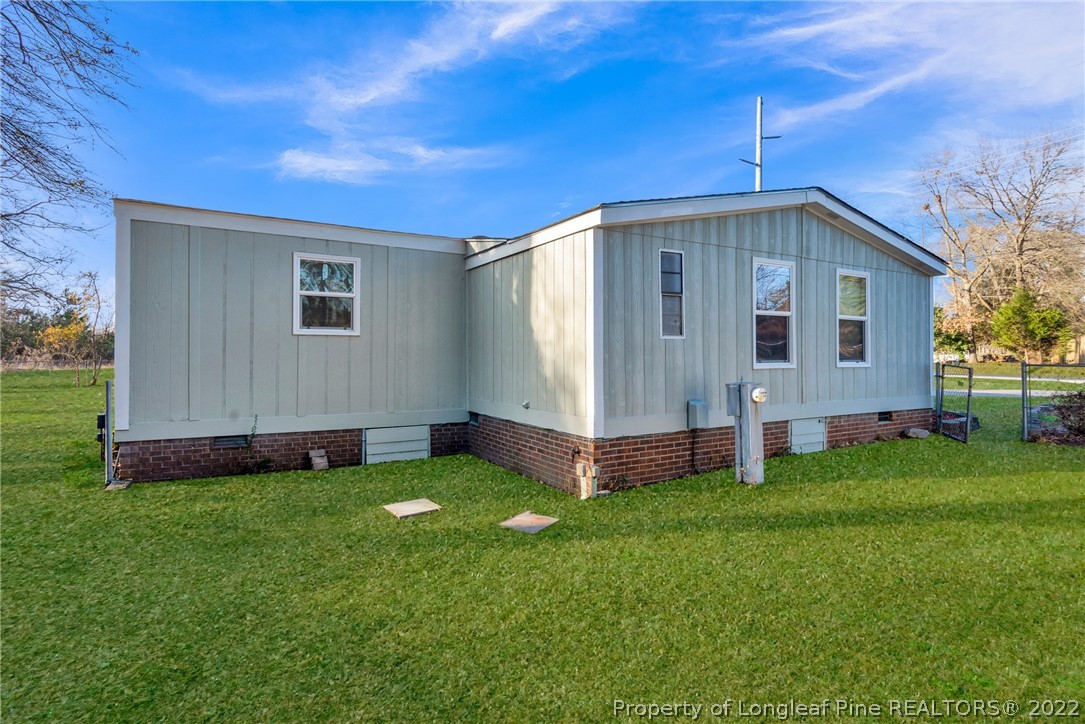 6129 Fisher Road Fayetteville, NC 28306 - Photo 27 of 31 a view of a house with a yard