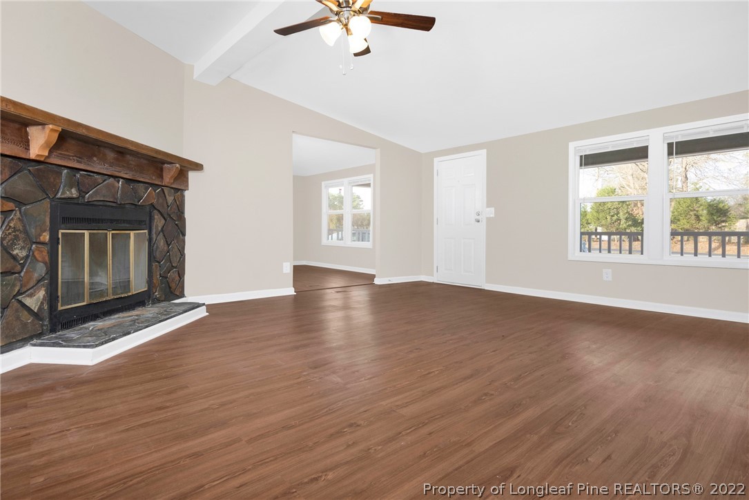 6129 Fisher Road Fayetteville, NC 28306 - Photo 5 of 31 a view of an empty room with wooden floor and a window
