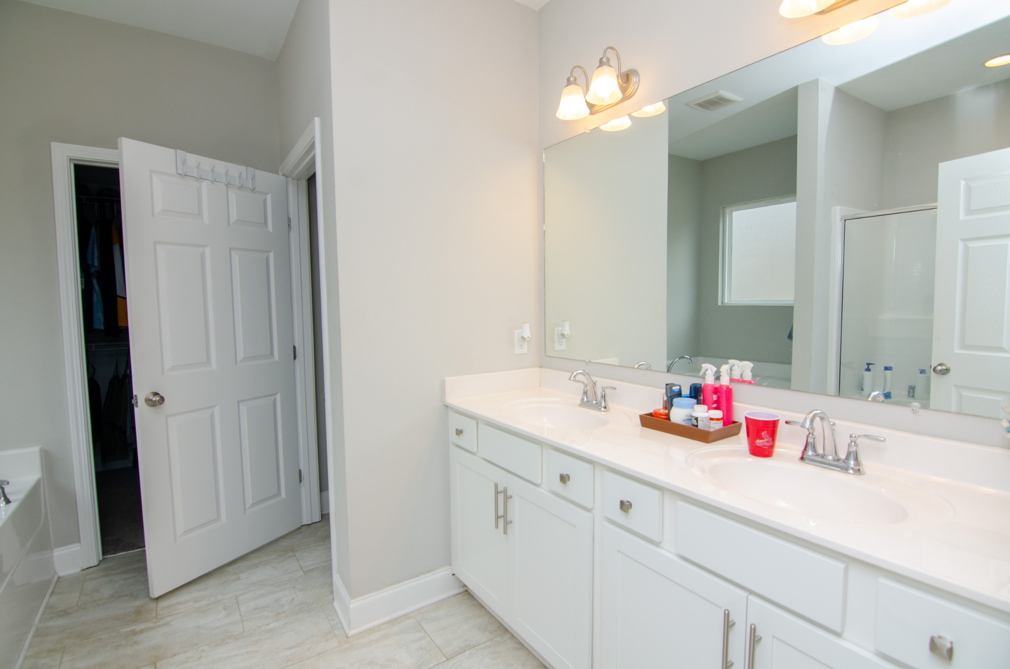 1060 Westgate Drive Gallatin, TN 37066 - Photo 16 of 31 a bathroom with a double vanity sink and a mirror