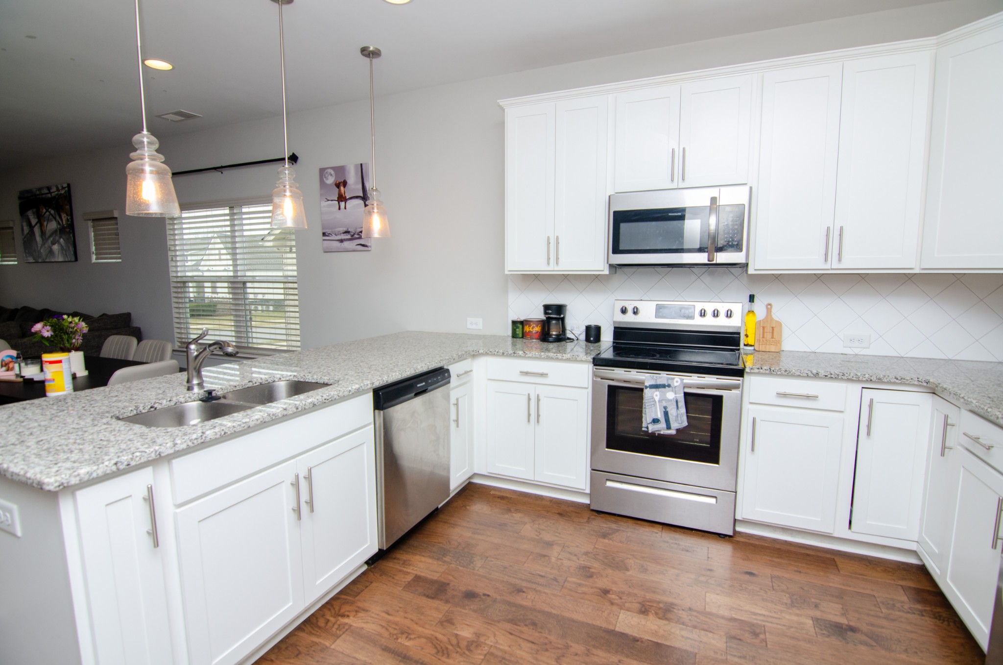 1060 Westgate Drive Gallatin, TN 37066 - Photo 9 of 31 a kitchen with white cabinets and white appliances