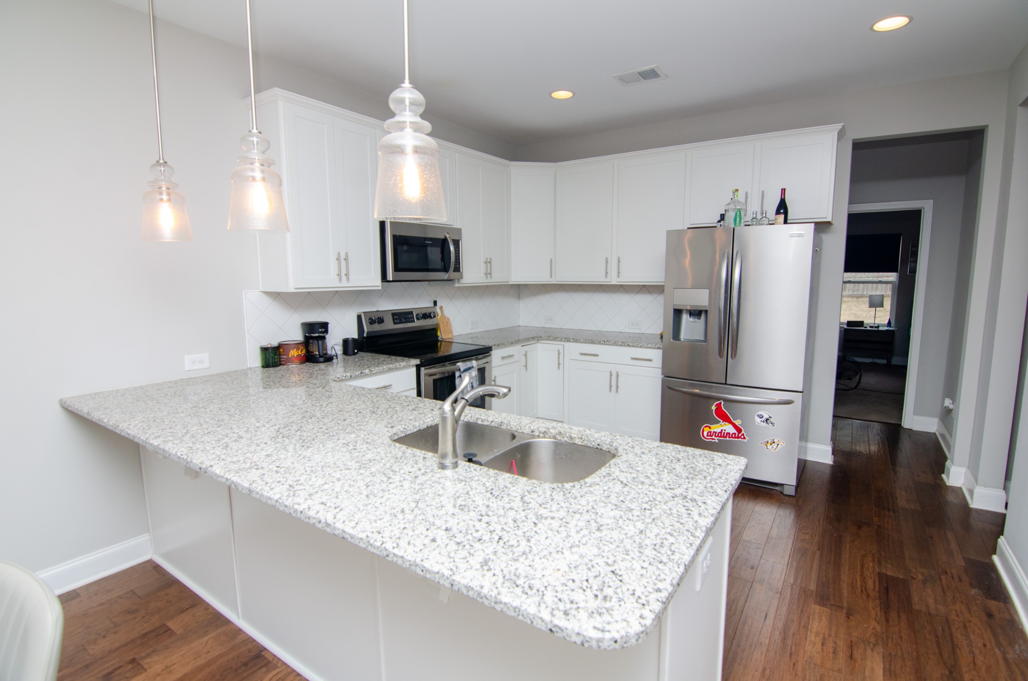 1060 Westgate Drive Gallatin, TN 37066 - Photo 10 of 31 a kitchen with stainless steel appliances granite countertop a sink refrigerator and microwave